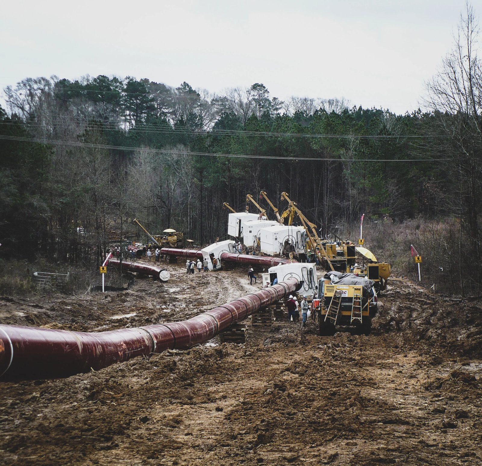 Pipeline construction spread with automated ultrasonic shelters and sidebooms on a wooded right-of-way
