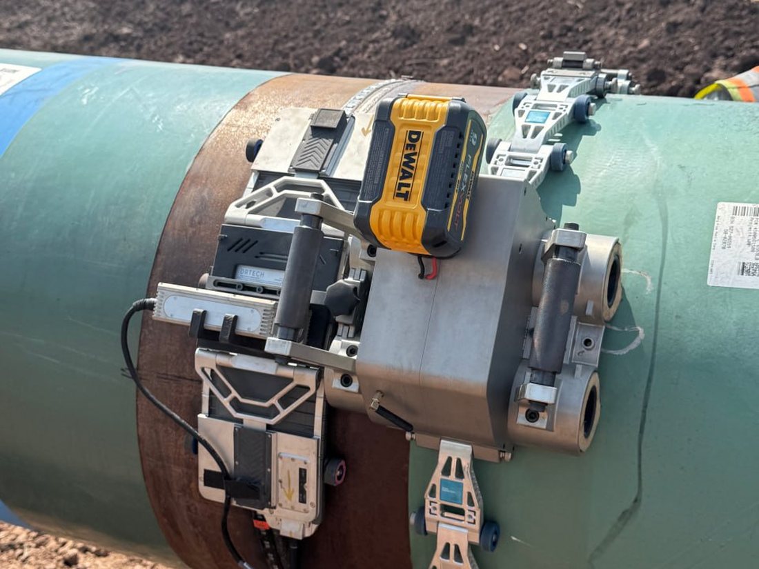 Automated ultrasonic (AUT/UT Scan) scanner inspecting a coated pipeline girth weld