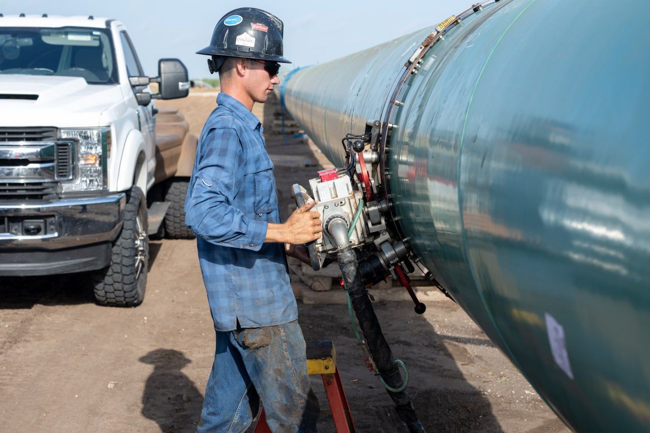 UT Quality union technician running an automated ultrasonic (AUT) scanner on a pipeline girth weld